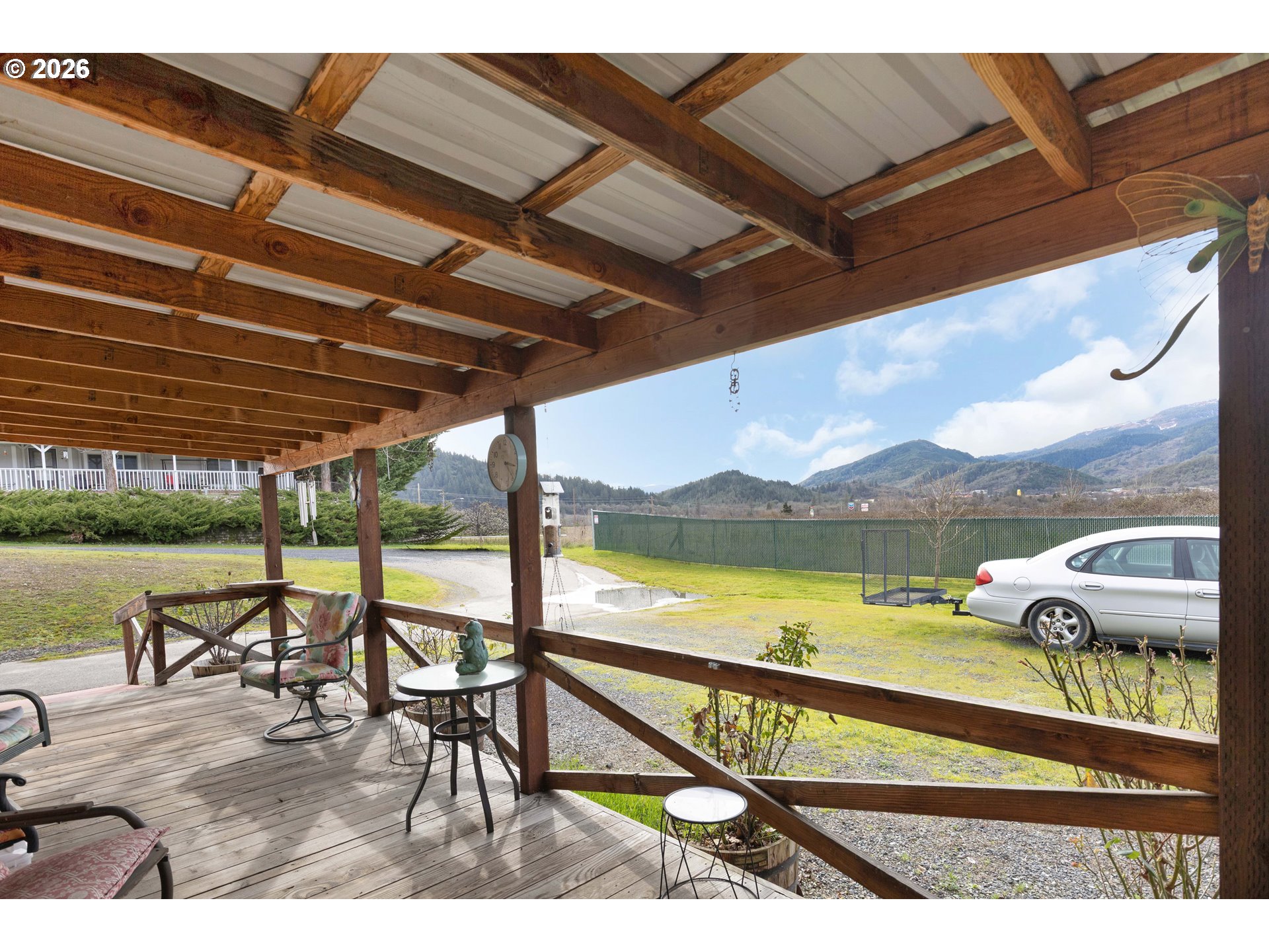 583 Suncrest Street Myrtle Creek, OR 97457 - Photo 24 of 24 a view of a swimming pool with a table and chairs under an umbrella