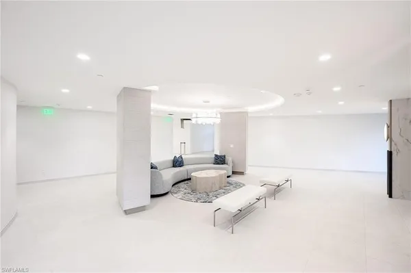 a large white kitchen with white cabinets