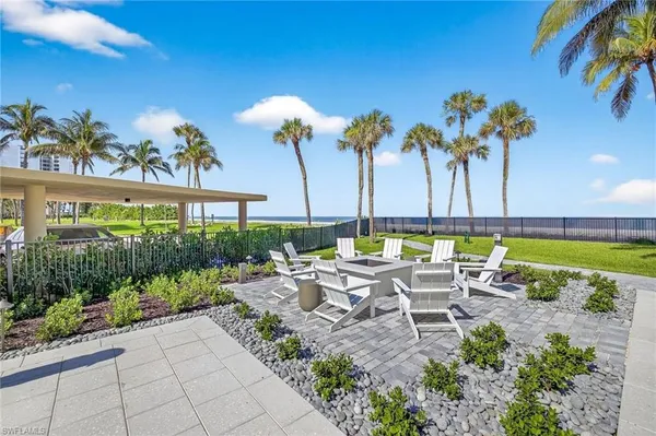 a view of a patio with a table and chairs and a garden