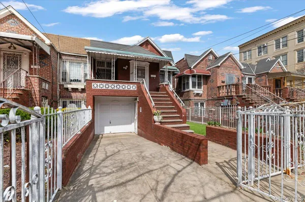 a view of a house with wooden fence