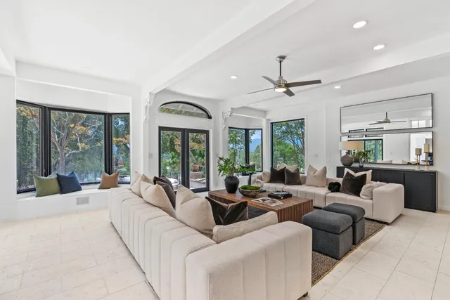 a kitchen with stainless steel appliances granite countertop a refrigerator a stove and a sink