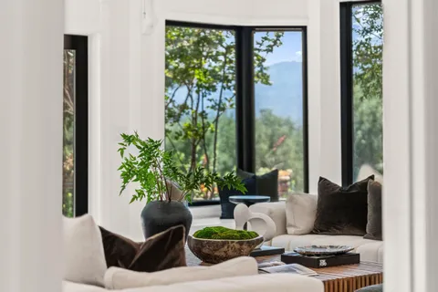 a living room with furniture and large windows