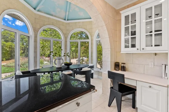 a bathroom with a tub and glass window
