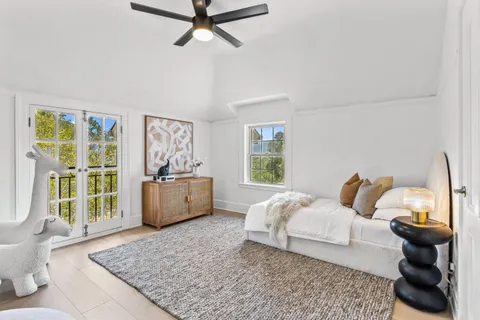 a view of a patio with chairs and potted plants