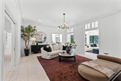 a living room with furniture and large windows