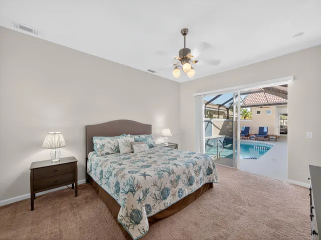 a bedroom with a bed chandelier and window