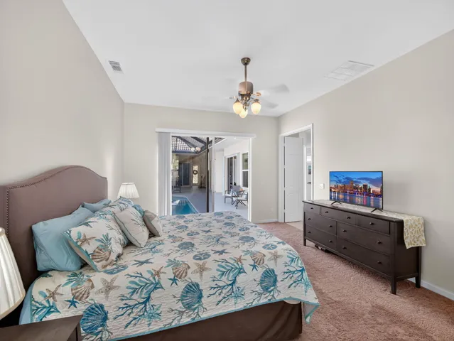 a bedroom with a large bed and a chandelier