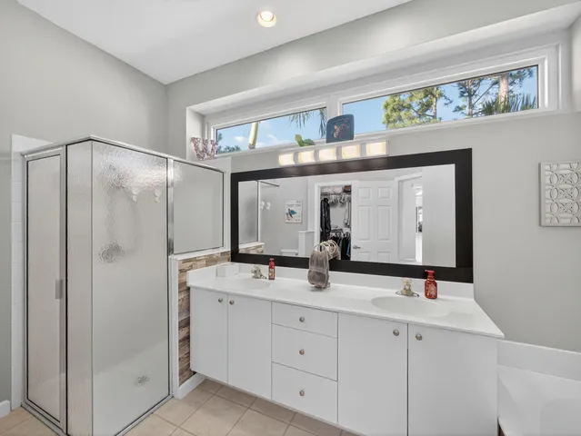 a bathroom with a double vanity sink and a mirror