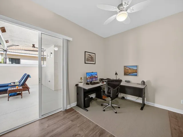 a view of a workspace with furniture and a window