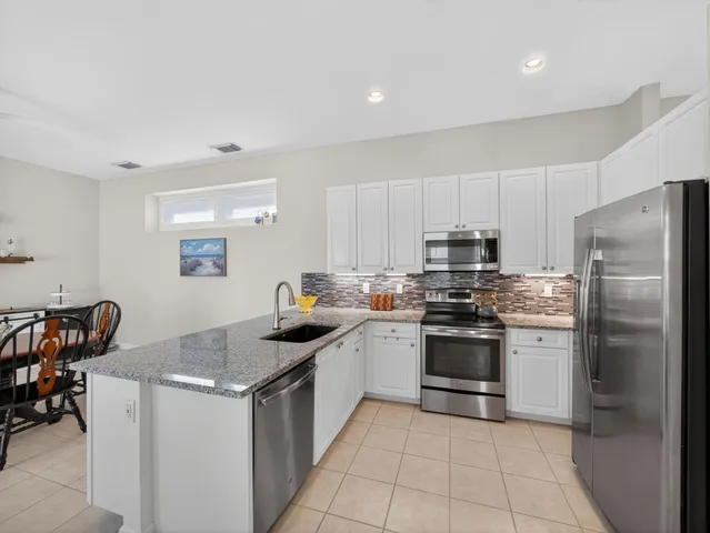 a kitchen with a stove a sink and a refrigerator