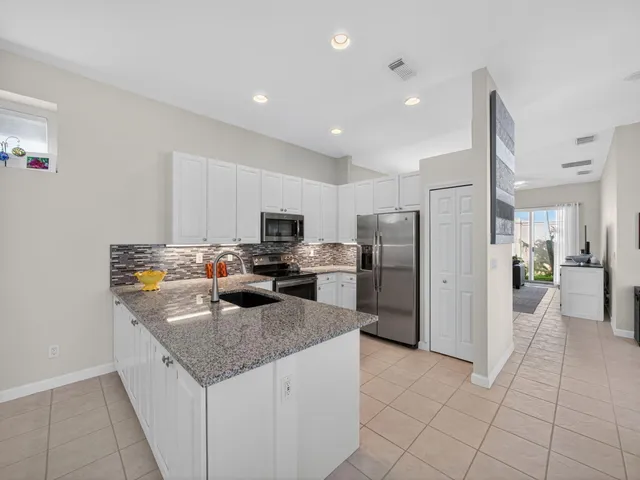 a kitchen with refrigerator and furniture