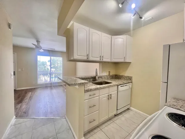 a kitchen with granite countertop a stove and a sink