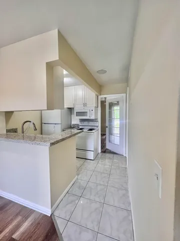 a kitchen with stainless steel appliances granite countertop a sink and cabinets