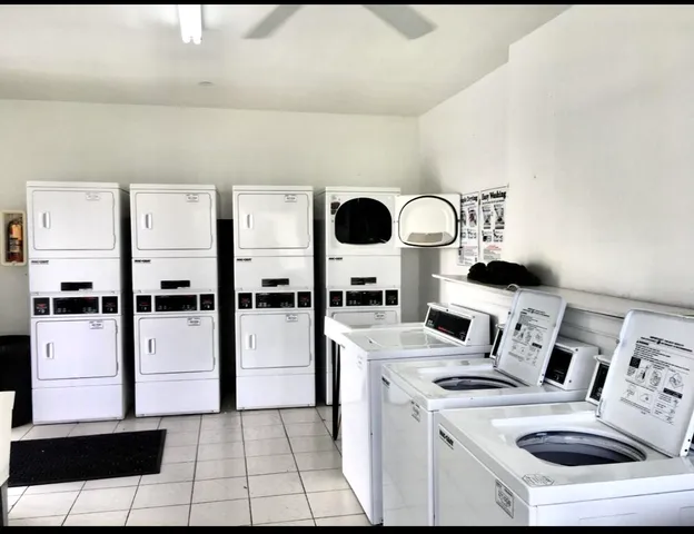 a kitchen with stainless steel appliances kitchen island a refrigerator sink and cabinets