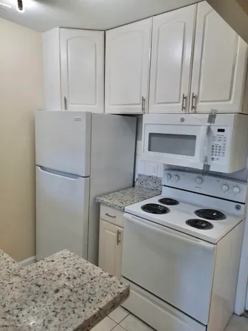 a kitchen with appliances and cabinets