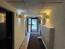 a view of hallway with wooden floor