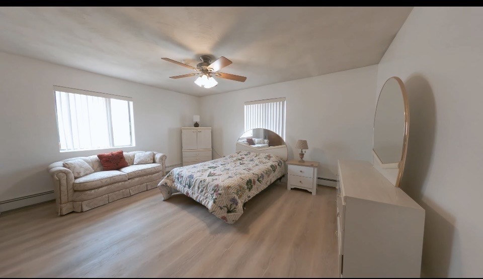 141 Pierce Street, Unit 12 Malden, MA 02148 - Photo 5 of 15 a bedroom with a bed couch and window