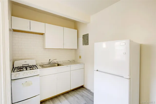 a white refrigerator freezer sitting inside of a kitchen