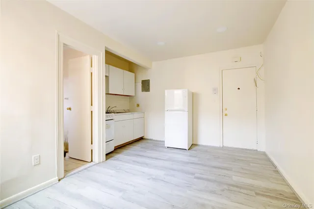 a view of a kitchen with a sink and a refrigerator