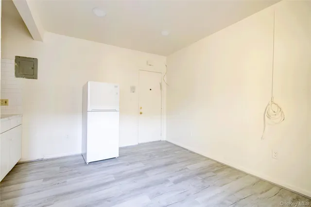 a view of a room with wooden floor