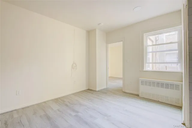 an empty room with a empty space and windows