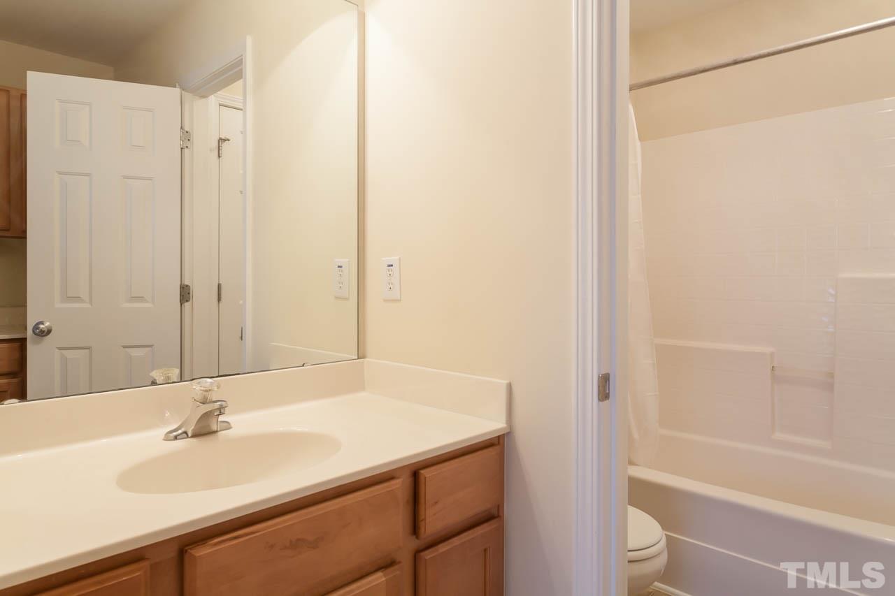 3601 Weir Way Raleigh, NC 27616 - Photo 14 of 25 a bathroom with a sink and a bathtub