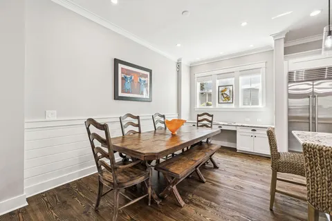 a large kitchen with kitchen island a sink table and chairs