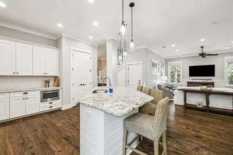 a kitchen with granite countertop a stove and a wooden floor