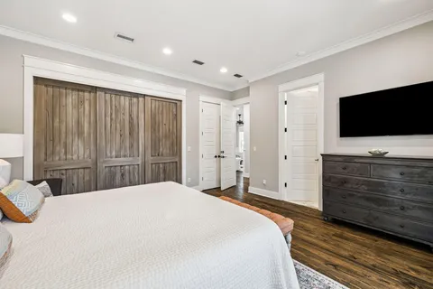 a bedroom with a bed and a ceiling fan