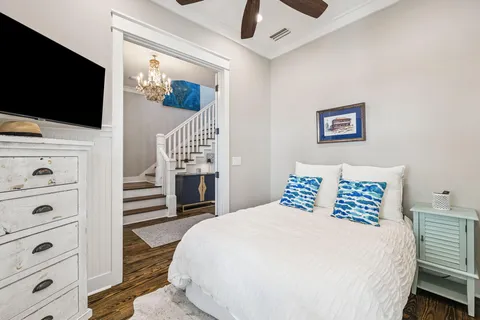 a bedroom with a bed and a chandelier