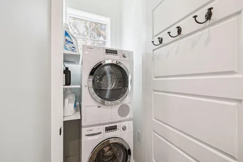 a bathroom with a double vanity sink mirror and bathtub