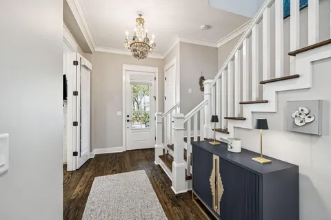 a living room with furniture a flat screen tv and a large window