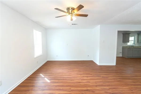 wooden floor in an empty room with a window