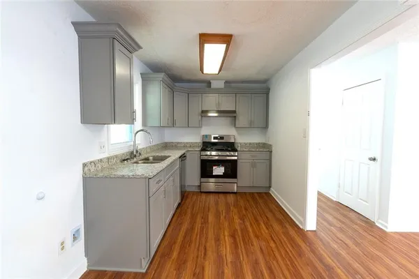 a kitchen with a sink and a stove top oven