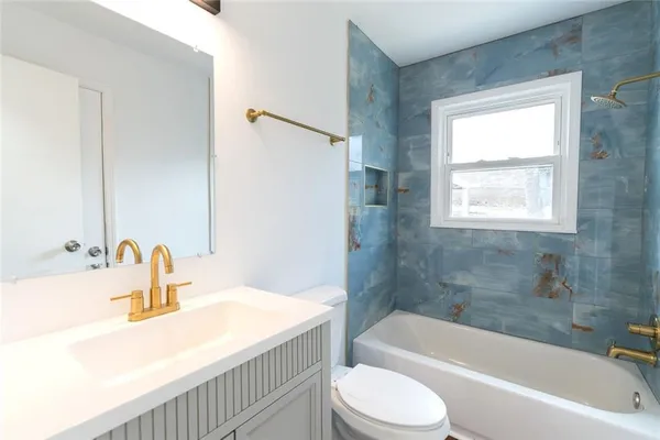 a bathroom with a sink a toilet and bathtub