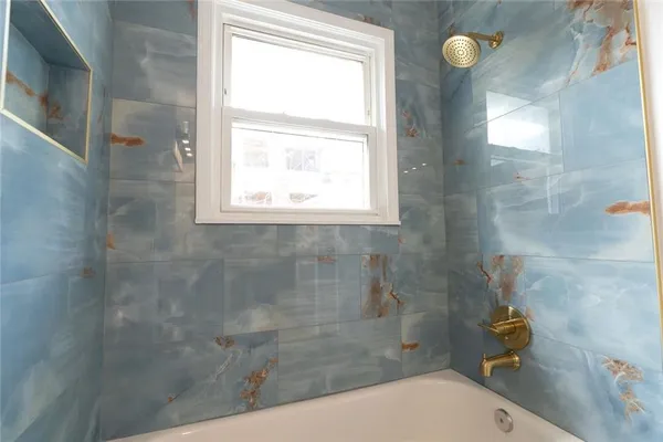 a bathroom with a granite countertop sink a toilet and a shower