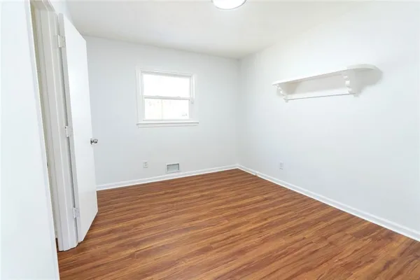 a view of a room with wooden floor