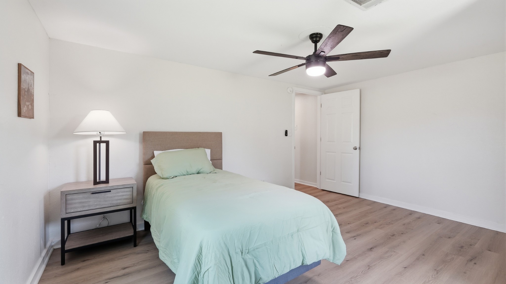 469 Fred Cooper Road McMinnville, TN 37110 - Photo 26 of 46 a bedroom with a bed and a lamp