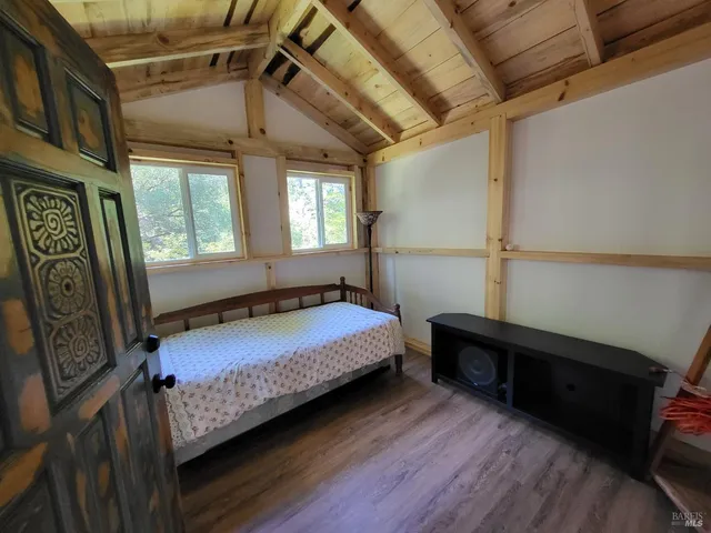 a bedroom with bed and a window