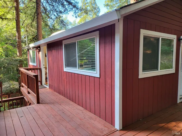 a view of backyard with a deck and wooden floor