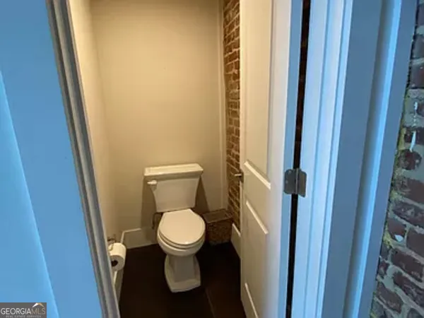 a white toilet sitting next to a sink