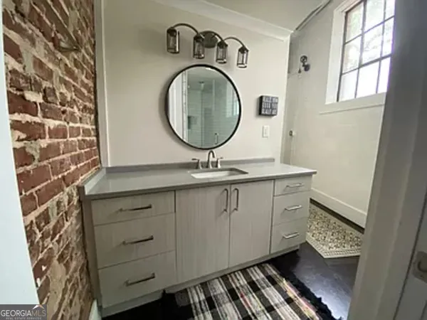 a bathroom with a sink a mirror and a toilet