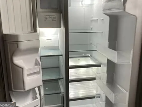 a refrigerator freezer sitting inside of a kitchen