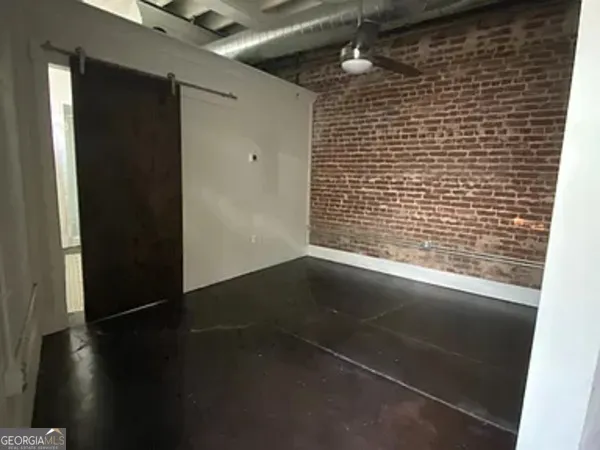 a view of a livingroom with wooden floor and a window
