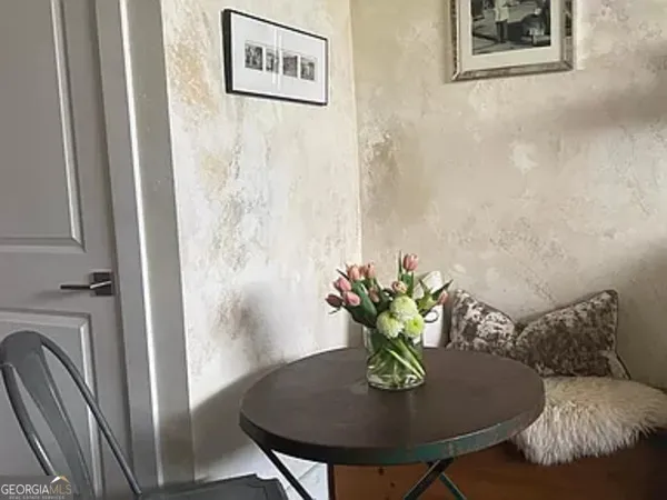 a view of a dining room with furniture and a potted plant