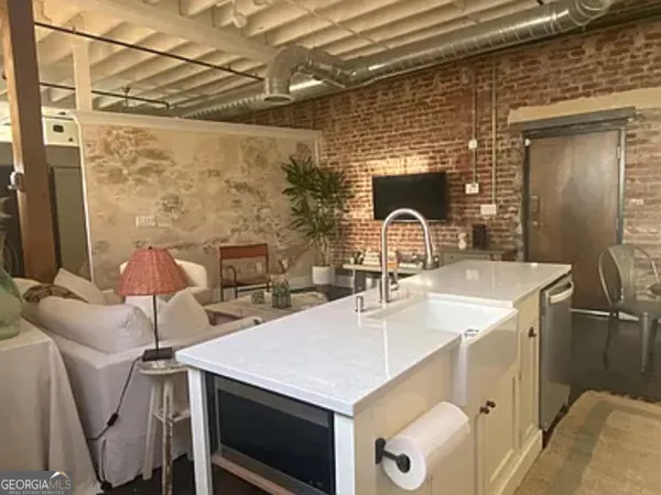 a kitchen with a sink a table and chairs
