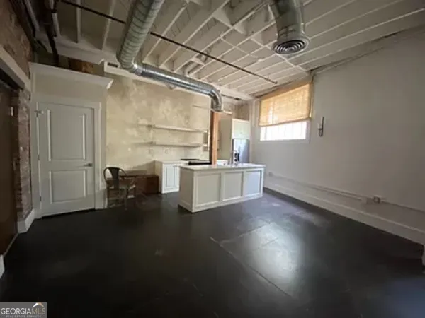 a view of a room with wooden floors