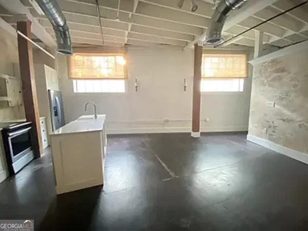 a view of a room with wooden floor and a window