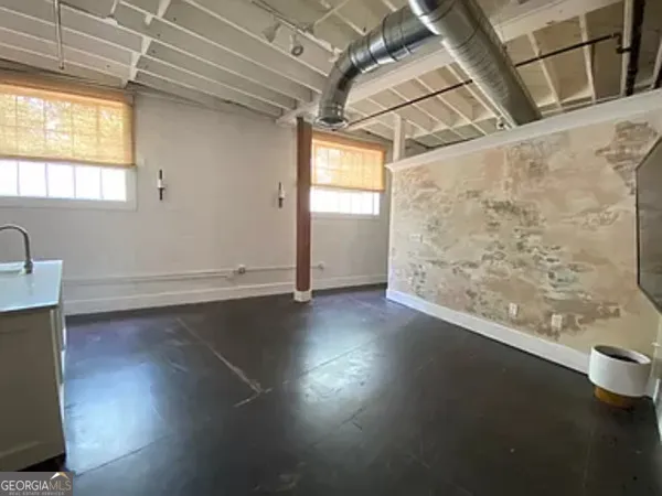 a view of a room with wooden floor and a window