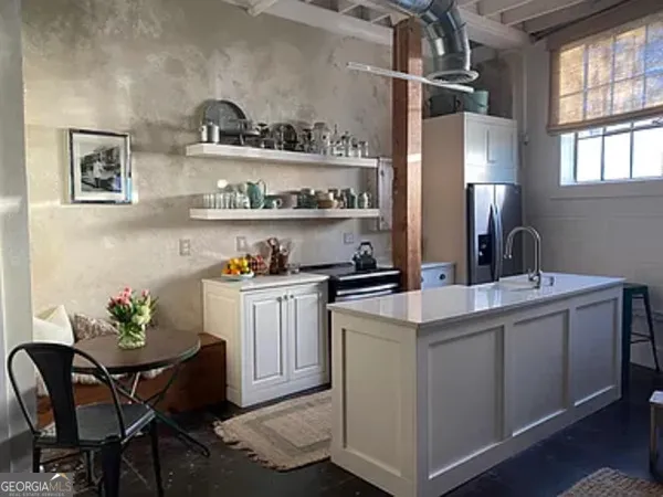 a kitchen with cabinets and window